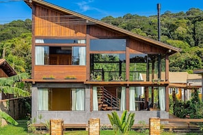 A modern two-story house with large windows, a balcony, and a staircase. - 3BR Duplex w/ BBQ & Garage Near Beach Emb686 (Bombinhas)