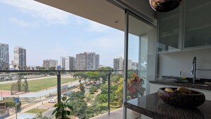 A modern kitchen with a large window overlooking a cityscape. - Beautiful  loft in Barranco (Barranco)