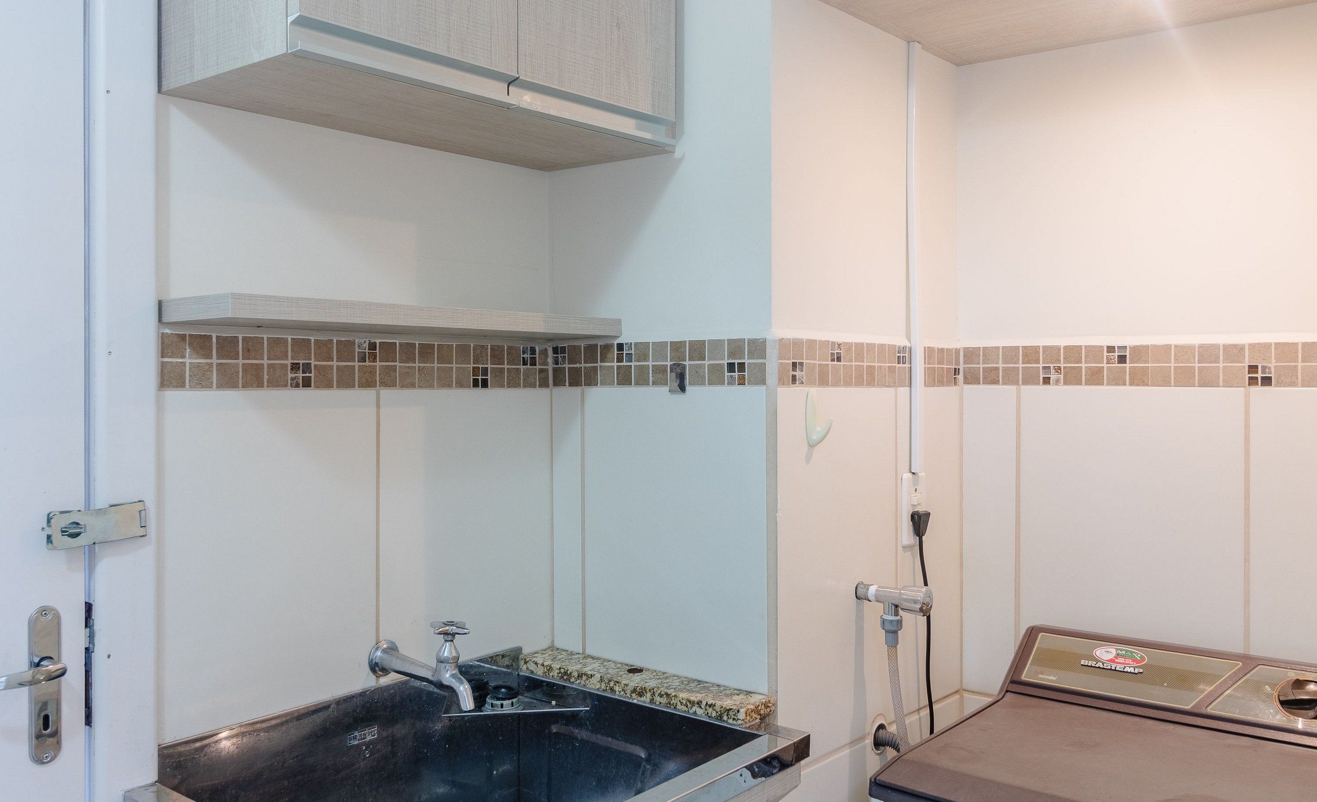 A bathroom with a sink, a toilet, and a shower area.