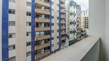 A multi-story residential building with balconies and a tiled facade.