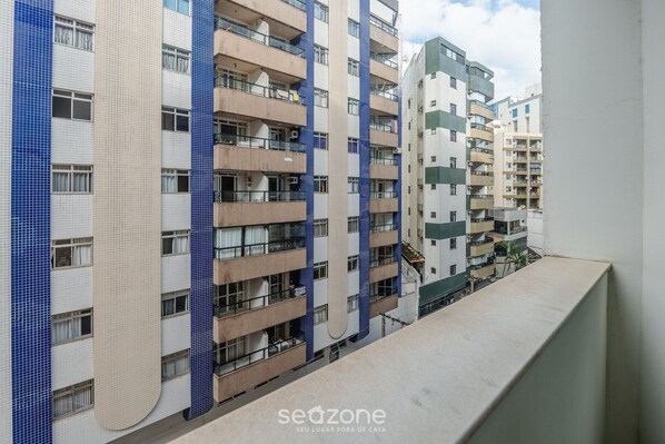 A multi-story residential building with balconies and a tiled facade.
