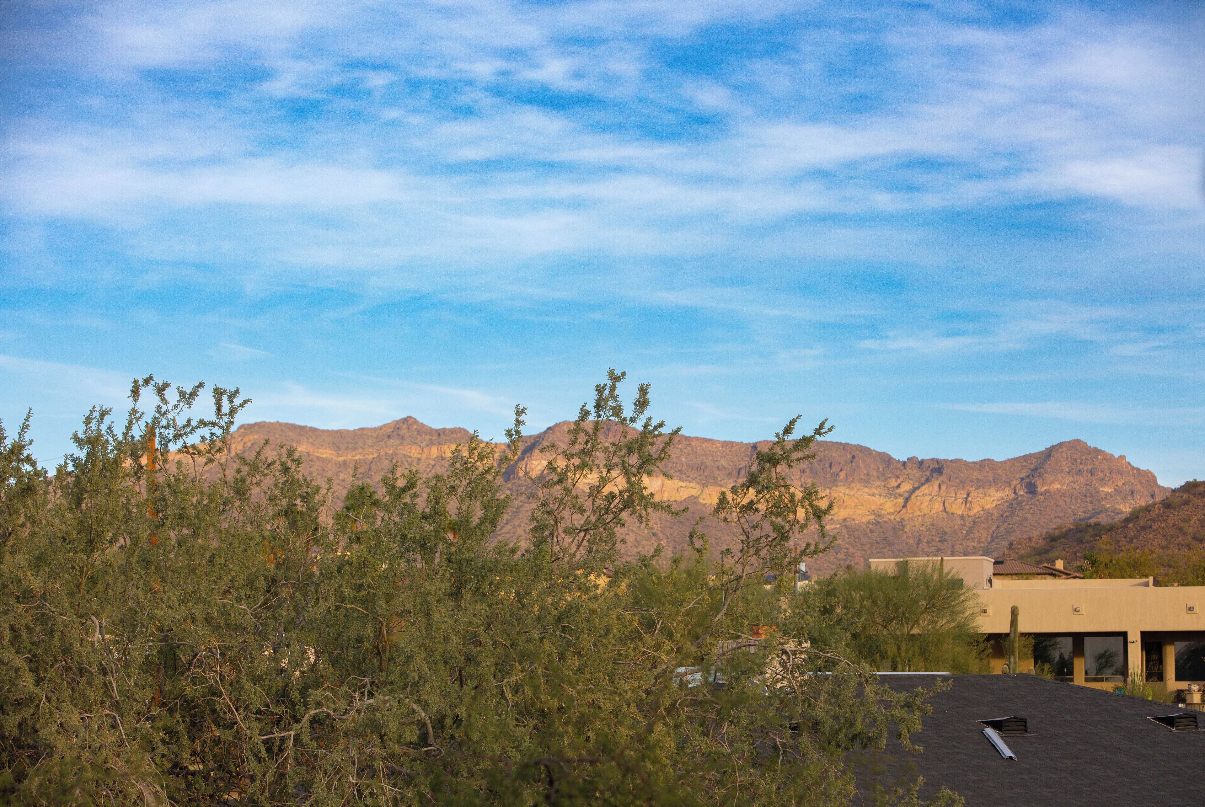 A building with a flat roof and a view of mountains in the background.