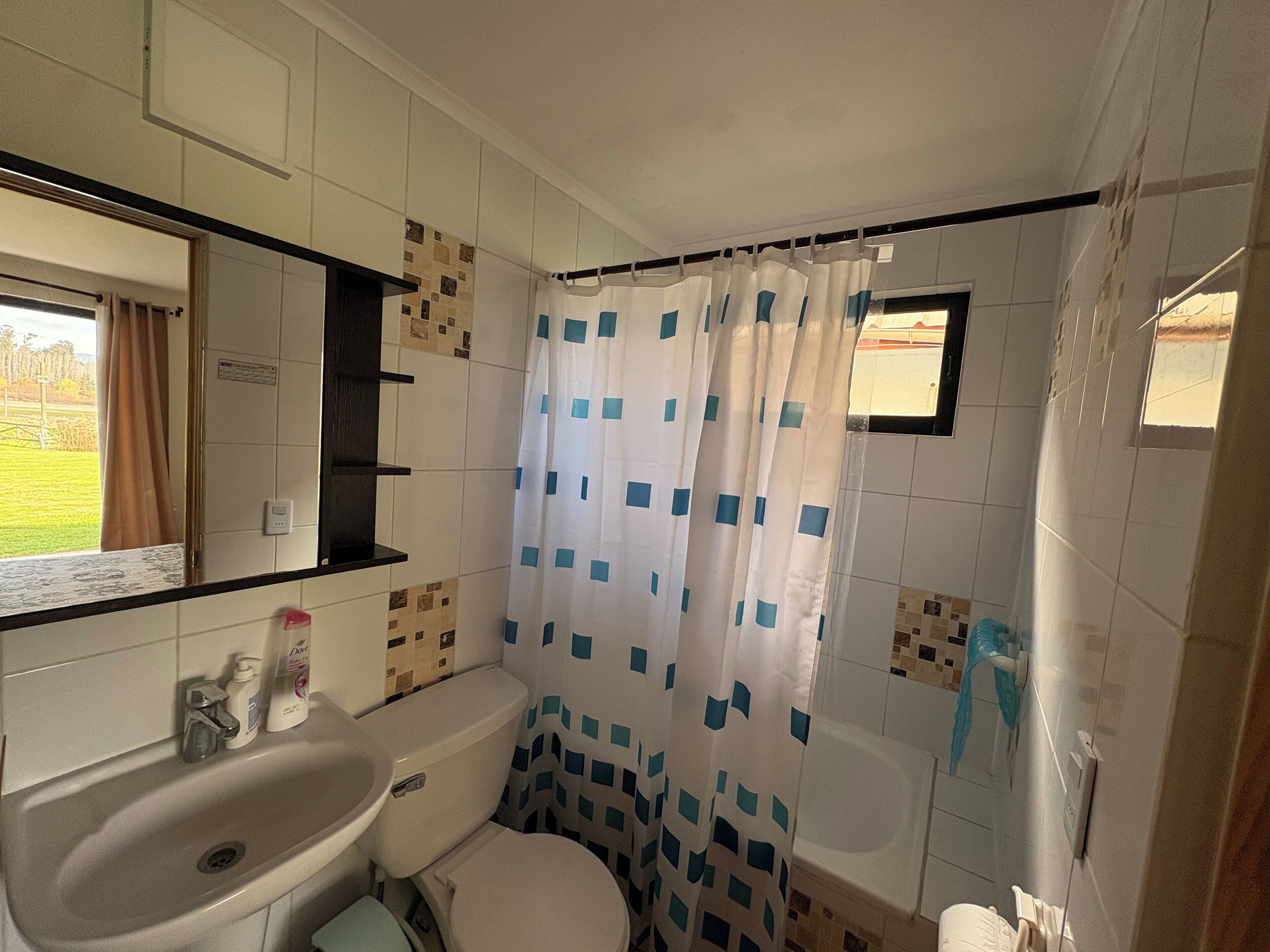 A small bathroom with a toilet, sink, and bathtub.