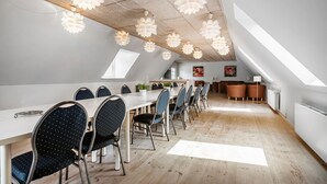 A modern dining area with a long table, chairs, and pendant lights. - Lovely home in Nimtofte with WiFi (Nimtofte)