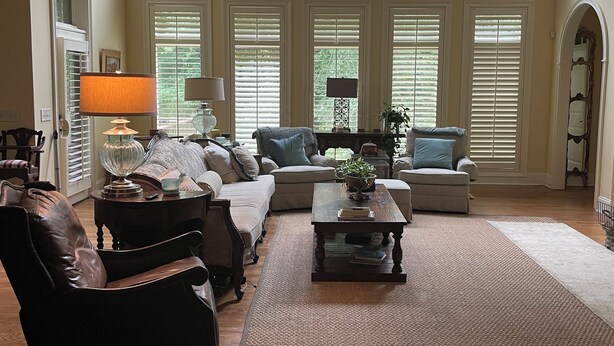 A spacious living room with a large window, a fireplace, and a cozy seating area. - Spacious 4 Bed 3 Bath Auburn Game Day Home (Auburn)