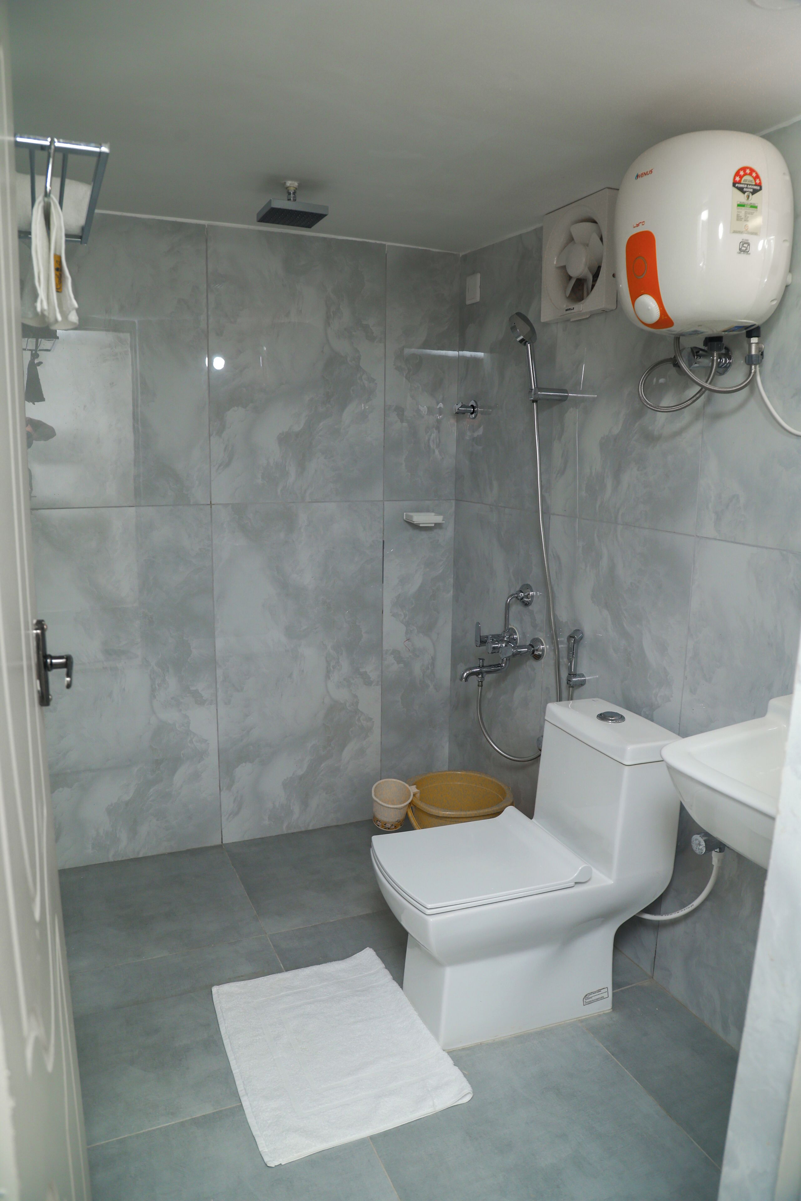 A bathroom with a shower, toilet, and sink.