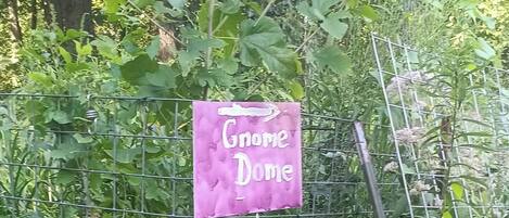 A garden area with a sign that reads "Gnome Dome."