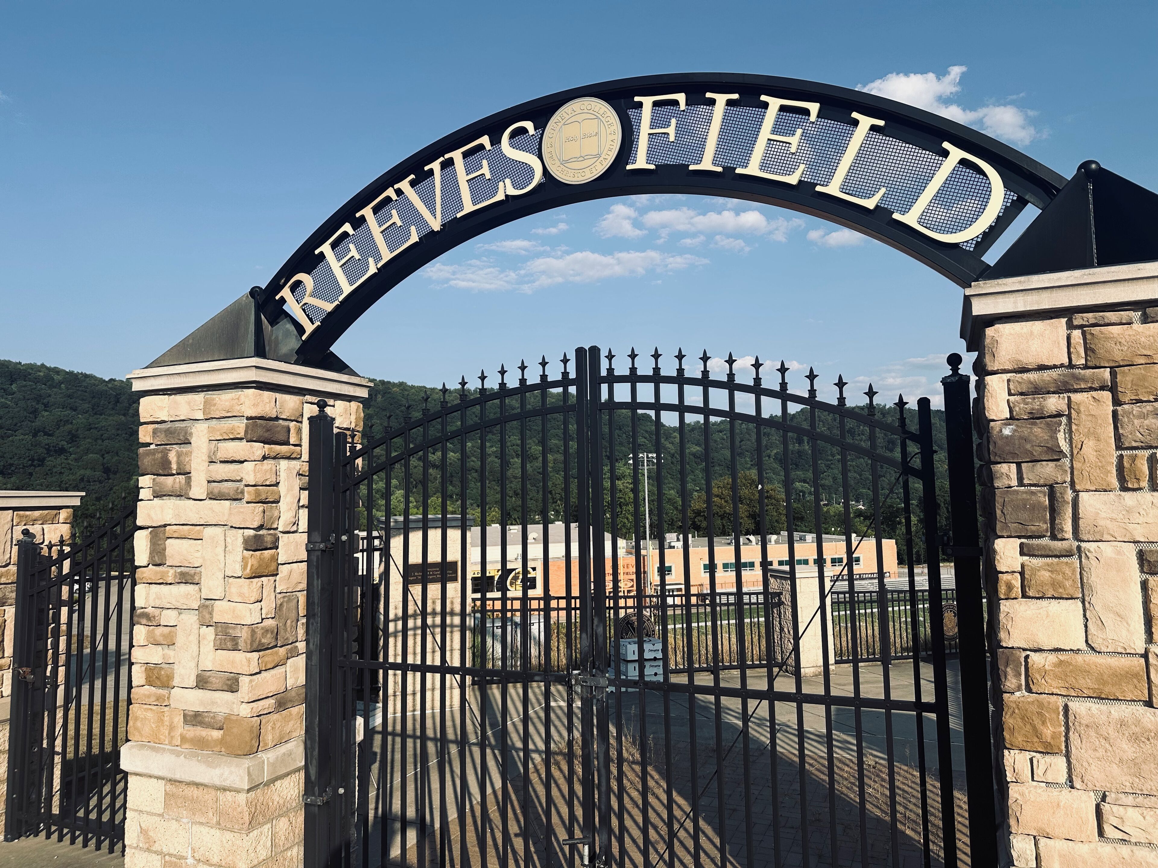 A gated entrance with the name "Reeves Field" prominently displayed above.