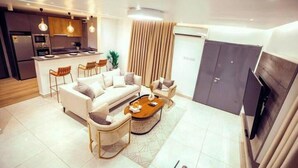 Una sala moderna con un conjunto de sofá, una mesa de centro y un comedor con sillas.