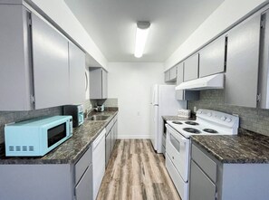 Fridge, stovetop, dishwasher, coffee/tea maker