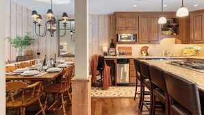 A kitchen with wooden cabinets, a dining table set for six, and pendant lighting.