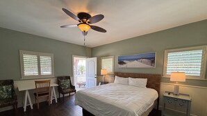 A bedroom with a bed, a desk, a chair, a nightstand, a lamp, and a ceiling fan. - Pet Friendly, Close to the Beach, Golf Cart Access (Port Aransas)