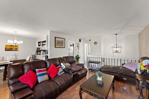 TV connectée, cheminée, livres, écrans d'ordinateur