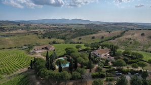 A vineyard estate with two buildings, a swimming pool, and a scenic view of rolling hills and mountains. - Podere Delle Vigne, in the Vineyards of Maremma (Grosseto)