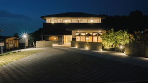 A modern two-story house with a paved driveway and outdoor lighting. - BRANCHERA ISHIBUTAI TERRACE (Asuka)