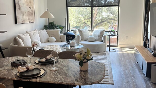 A modern living room with a dining area, large windows, and a minimalist design. - Ultra Chic 1-bedroom apartment with AC, fitness room in cool Austin (Austin)