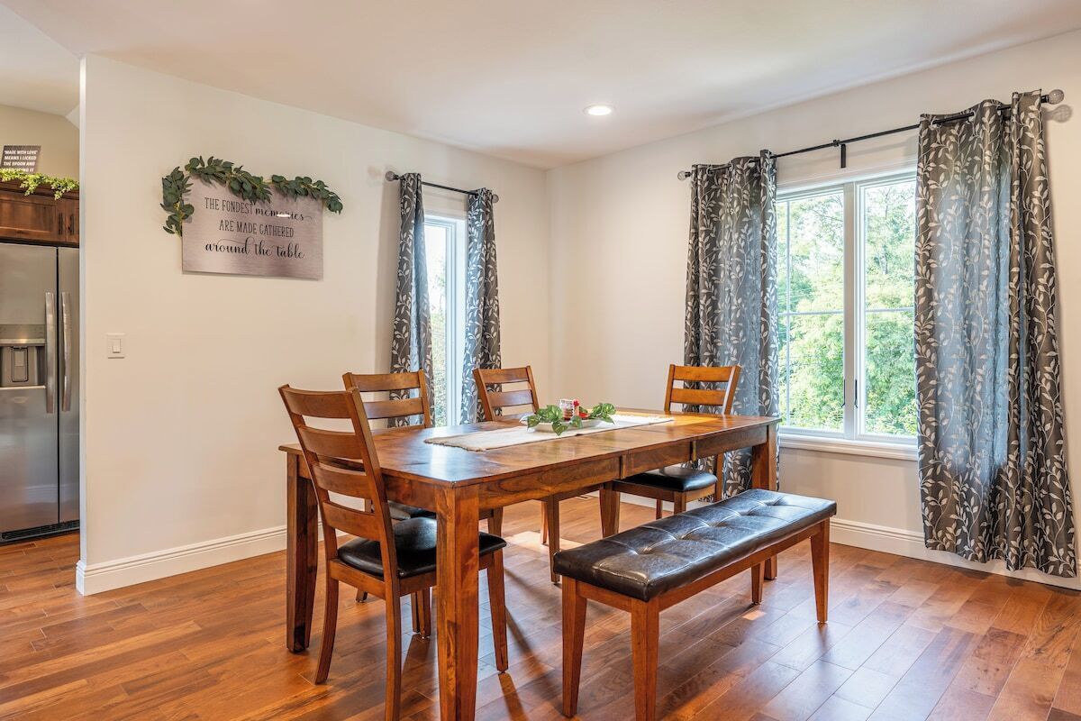 A dining area with a wooden table, chairs, and a bench.