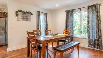 A dining area with a wooden table, chairs, and a bench.