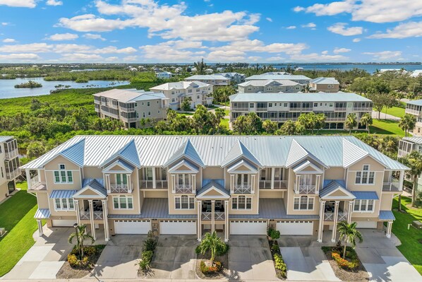 A large, multi-story residential building with a symmetrical facade, multiple balconies, and a central entrance.