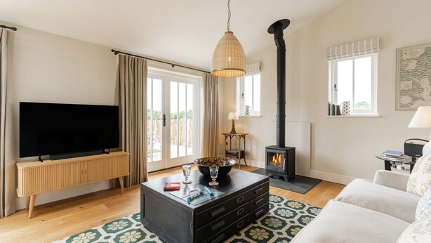 A living room with a TV, a fireplace, a sofa, and a coffee table.