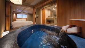 A modern hotel room with a large bathtub, wooden paneling, and a visible bathroom area. - Nazuna Kyoto Nishi Honganji (Kyoto)