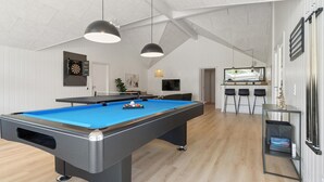 A pool table in a room with a high ceiling and white walls. There are two hanging lights above the table. - VillaVilla 807 - Fjellerup, Østjylland (Glesborg)