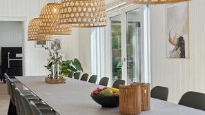 A dining area with a long table, wicker baskets, candles, and a bowl of fruit. - VillaVilla 809 - Fjellerup, Østjylland (Glesborg)