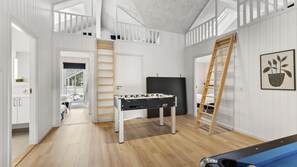 A spacious room with a foosball table, a ladder, and a potted plant on the wall. - VillaVilla 810 - Fjellerup, Østjylland (Glesborg)