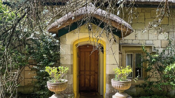 A rustic building with a wooden door and a thatched roof entrance. - 3 bedroom accommodation in Tisbury (Tisbury)