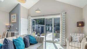 A modern living room with a sofa, armchair, and a coffee table. - 2 bedroom accommodation in Chapel St Leonards, near Skegness (Chapel St Leonards, near Skegness)
