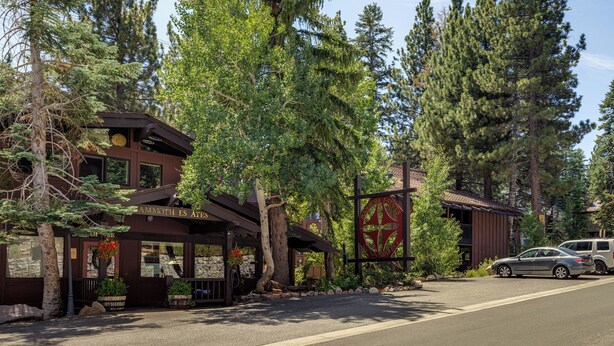 A lodge with a rustic exterior, large windows, and a prominent entrance.