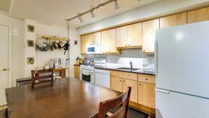 A kitchen with wooden cabinets, a white refrigerator, a microwave, a stove, and a dishwasher. - 1/2 Mi to Metrobus Stop! Walkable Petworth Duplex (Washington)