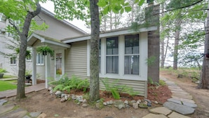 A house with a stone pathway leading to the front door, surrounded by trees and a small garden. - Lakefront Lookout! Private Sand Beach on Superior (Marquette)