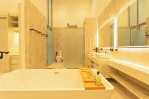 A modern bathroom with a large bathtub, a shower, and a vanity with a mirror. - NicestInPhuket4Br1.5kmBangTao BeachV141 (Choeng Thale)