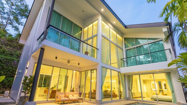 A modern two-story house with large glass windows, a pool, and a balcony. - NicestInPhuket4Br1.5kmBangTao BeachV141 (Choeng Thale)