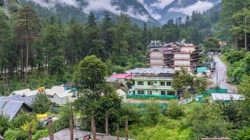 A mountainous village with traditional houses and a clear view of the valley below.