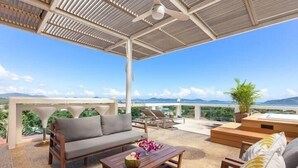 A covered outdoor seating area with a sofa, coffee table, and lounge chairs, overlooking a scenic landscape. - BestViewHot Tub pool Great Location v132 (Rawai)