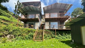 A two-story building with a staircase leading to a balcony. - Snow Adventure Resort (Dhanaulti)