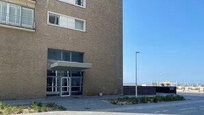 A modern building with a brick facade, large windows, and a covered entrance. - Apartment in Nieuwpoort-bad With Sea View (Nieuwpoort)