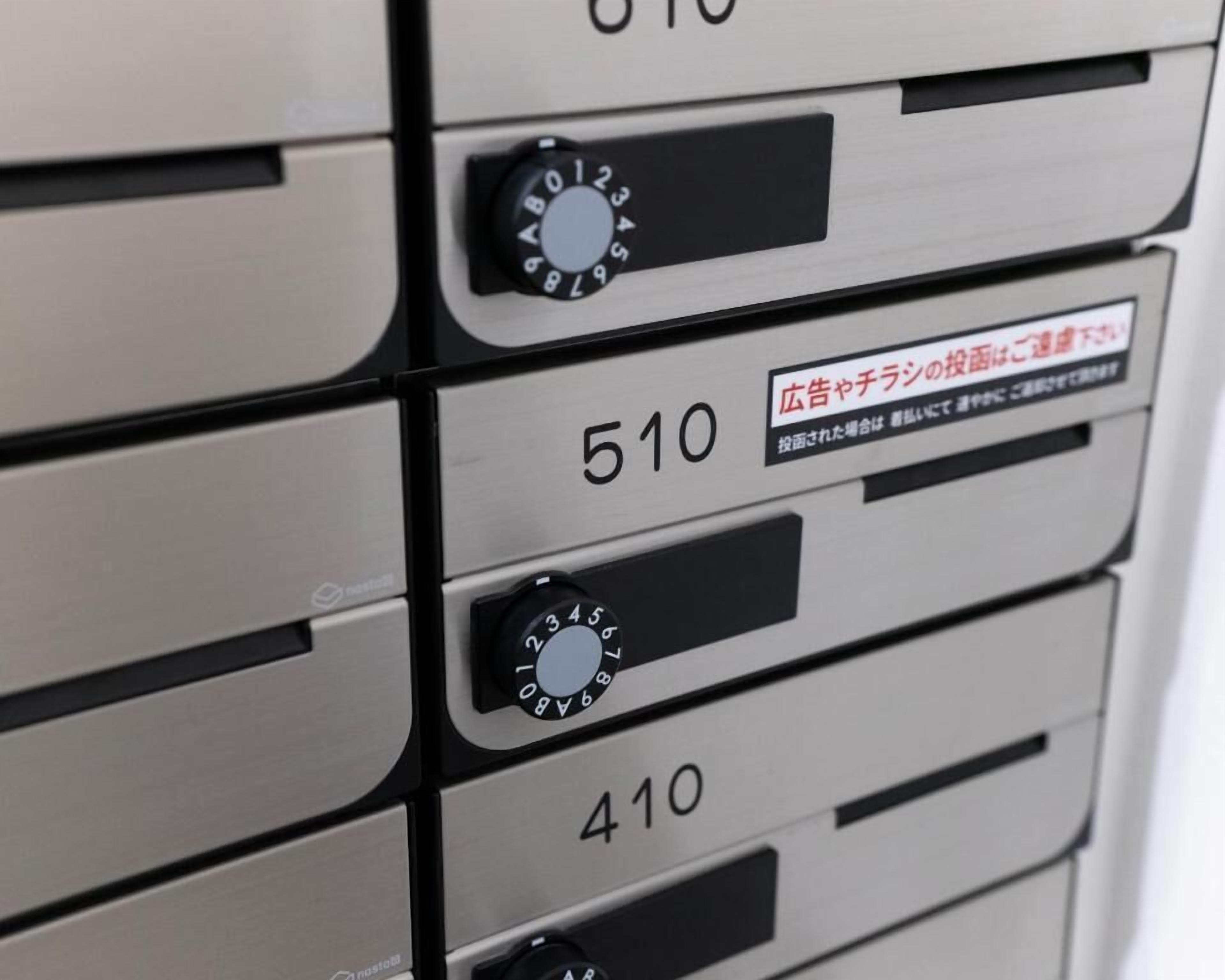 A close-up of a hotel room's storage compartment with multiple drawers, each labeled with a number.