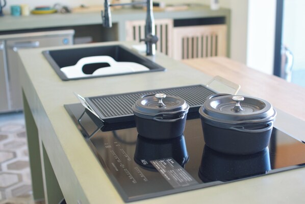 A kitchen with a modern design, featuring a built-in coffee maker and a kettle. - THE CHIKURA UMI BASE CAMP (Minamiboso)