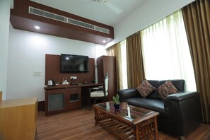 Deluxe Double Room | Living area | 32-inch LED TV with digital channels