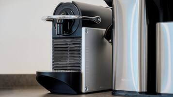 A coffee machine with a metallic finish and a control panel.