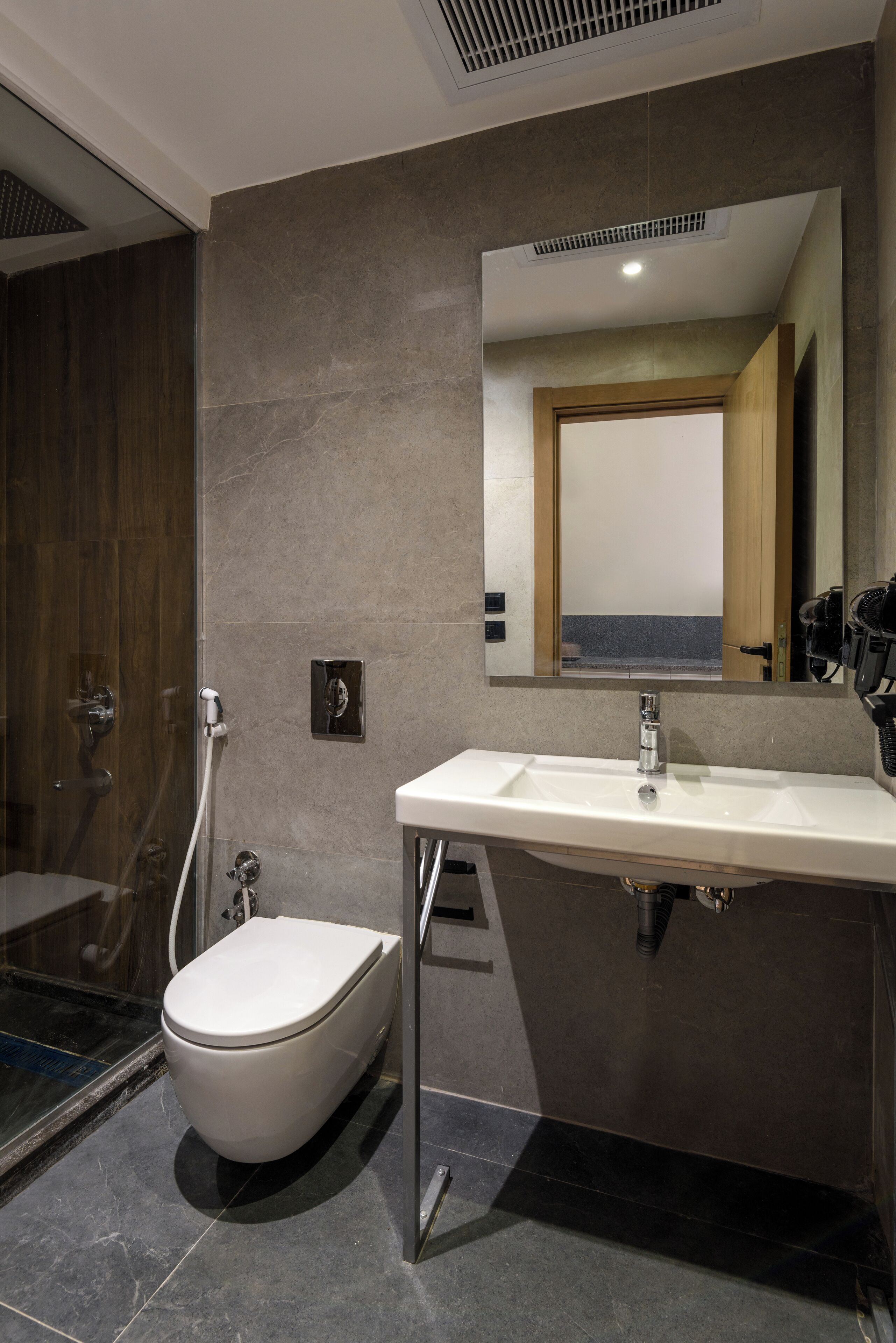 A modern bathroom with a bathtub, a sink, and a shower.