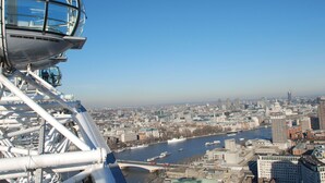 A cable car with a clear view of a cityscape and river.