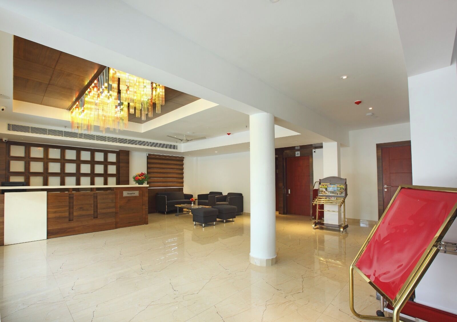 A spacious lobby with a reception desk, seating area, and a vending machine.