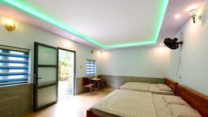 A room with two beds, a desk, and a chair. - ML Homestay (Ho Chi Minh City)