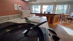 A kitchen with granite countertops, a toaster, and a window with a view of trees. - "Sea Song": Ocean Views, 2BD*, Ping Pong, Foosball (Crescent city)