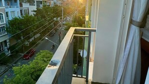 A balcony with a city view at sunset.