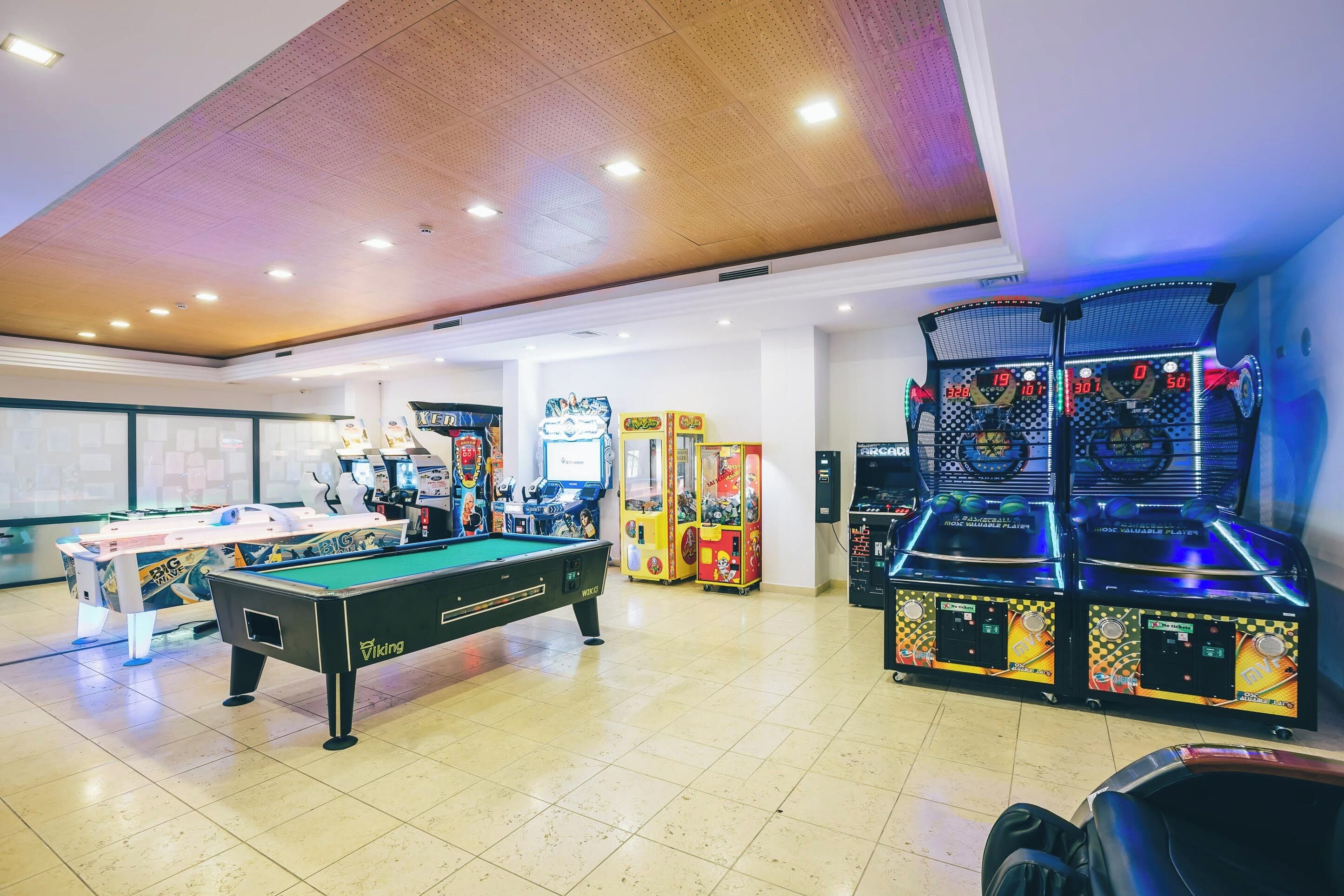 Play late with arcade games, pool table, and bright space.
